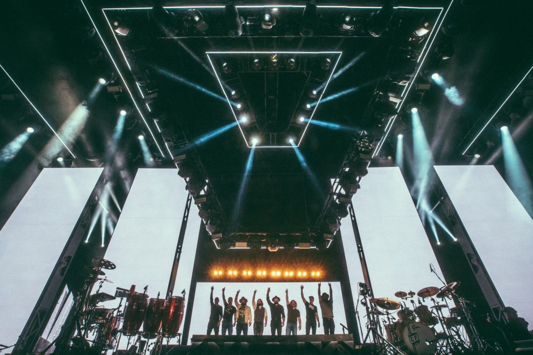 Daniel de los Reyes and Zac Brown Band taking a bow beneath a monumental stage rig